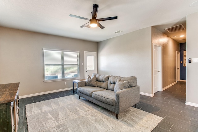 living room with ceiling fan and dark hardwood / wood-style floors