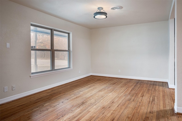 spare room with light hardwood / wood-style flooring