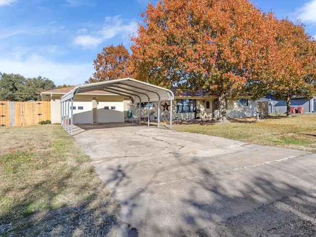 view of front of property with a carport and a front lawn