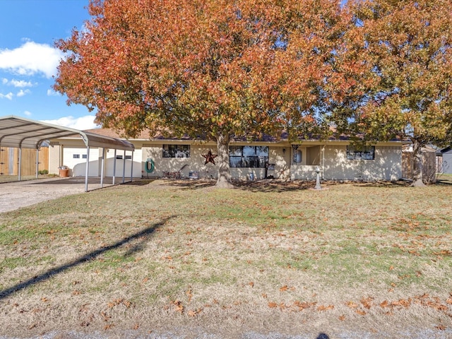 view of front of house with a carport, a garage, and a front lawn