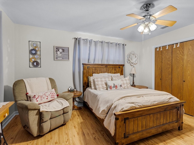 bedroom featuring ceiling fan, light wood-type flooring, and a closet