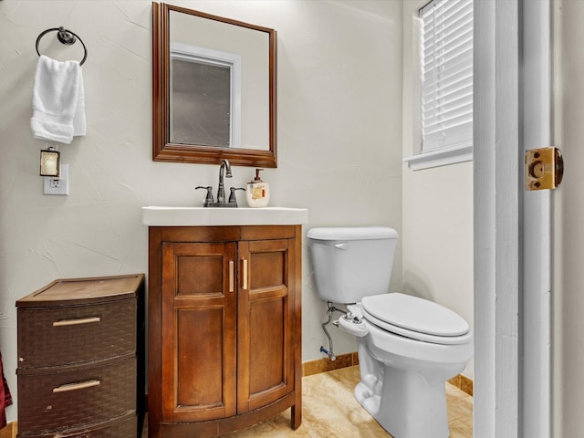 bathroom featuring vanity, tile patterned floors, and toilet