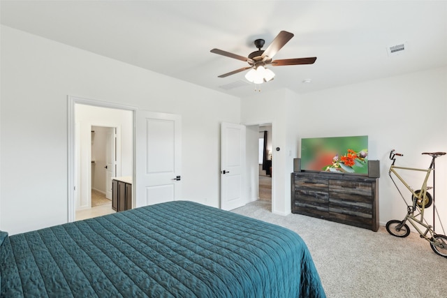 carpeted bedroom featuring connected bathroom and ceiling fan