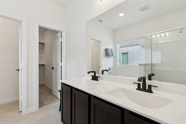 bathroom featuring vanity, tile patterned floors, and a shower with shower door