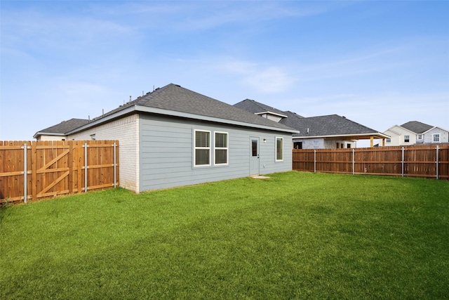 rear view of property featuring a yard