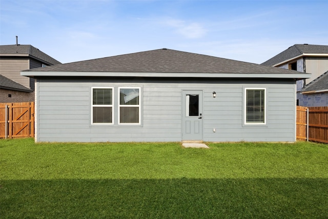 back of house featuring a yard