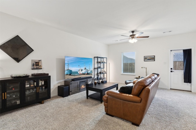 carpeted living room featuring ceiling fan and plenty of natural light