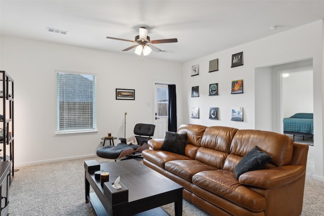 living room featuring ceiling fan and light colored carpet