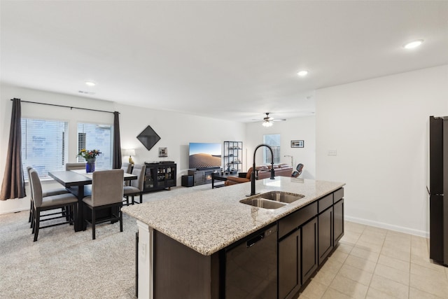 kitchen with ceiling fan, sink, stainless steel dishwasher, an island with sink, and dark brown cabinets