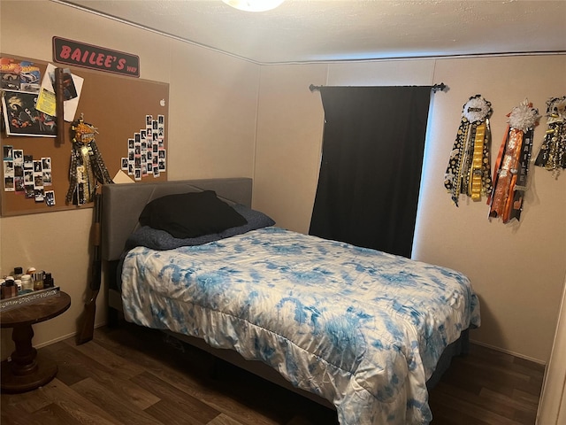 bedroom featuring dark hardwood / wood-style flooring