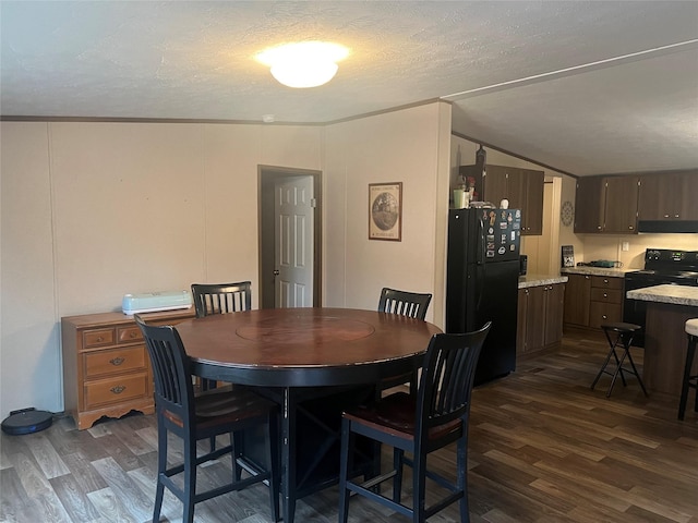 dining space featuring vaulted ceiling, crown molding, dark wood-type flooring, and a textured ceiling