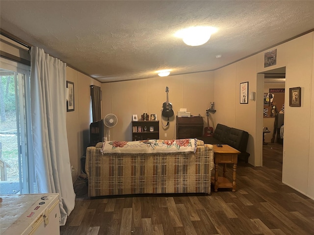 living room with a textured ceiling and dark wood-type flooring