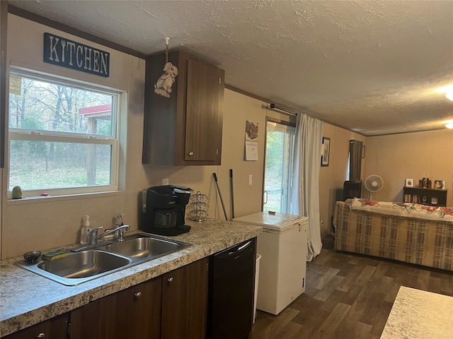 kitchen featuring dark brown cabinets, sink, refrigerator, and dark wood-type flooring