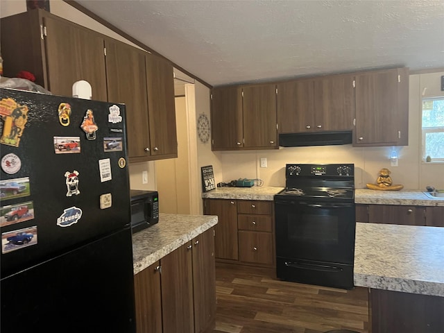 kitchen featuring dark brown cabinetry, ventilation hood, dark hardwood / wood-style floors, and black appliances