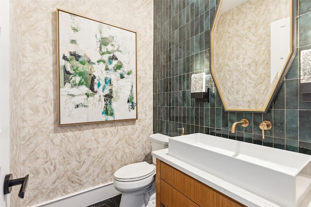 bathroom featuring vanity, toilet, tile walls, and a baseboard heating unit