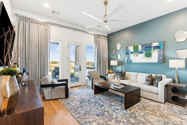 living room featuring ceiling fan and light wood-type flooring