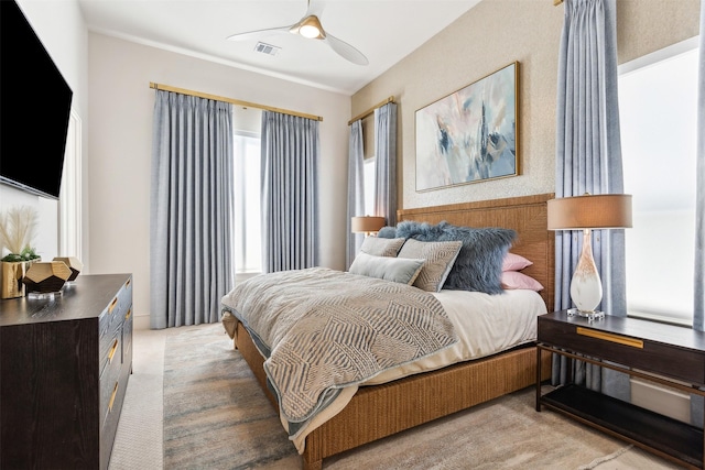 bedroom with light colored carpet and ceiling fan