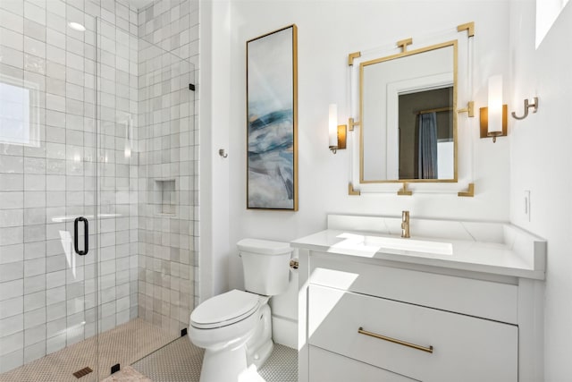 bathroom featuring a shower with door, vanity, and toilet