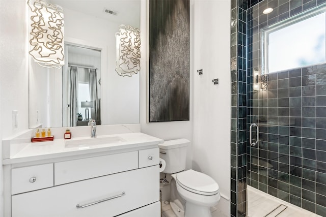 bathroom featuring vanity, a shower with door, and toilet