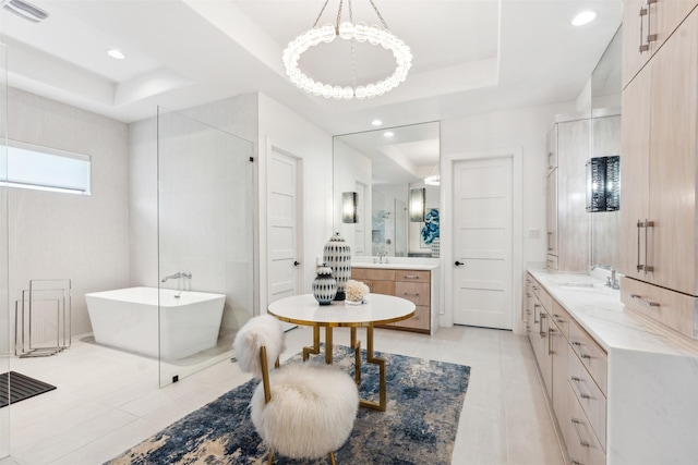 bathroom featuring independent shower and bath, vanity, tile patterned floors, and a tray ceiling