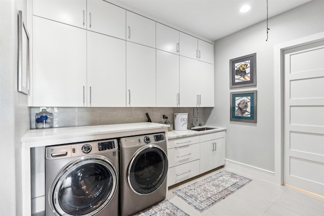 washroom with cabinets, separate washer and dryer, sink, and light tile patterned floors