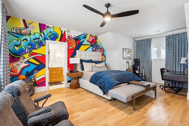 bedroom with ceiling fan, ensuite bathroom, and hardwood / wood-style floors