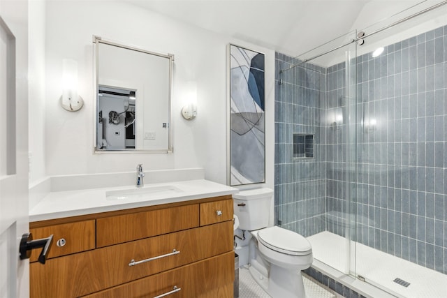 bathroom with a shower with door, vanity, and toilet