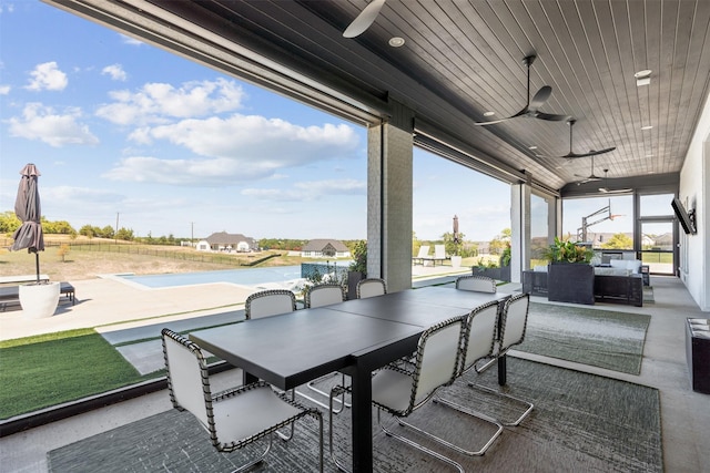 view of patio with an outdoor living space and ceiling fan