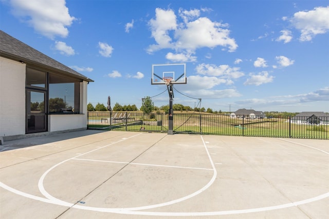 view of basketball court with a lawn