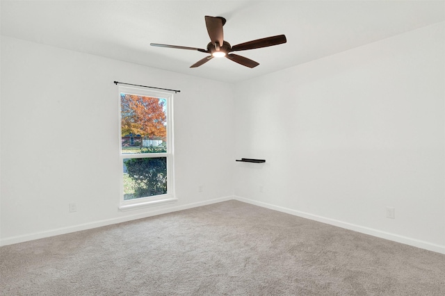 spare room featuring carpet floors and ceiling fan