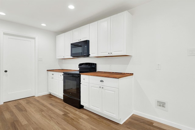 kitchen with black appliances, light wood-type flooring, white cabinetry, and wooden counters