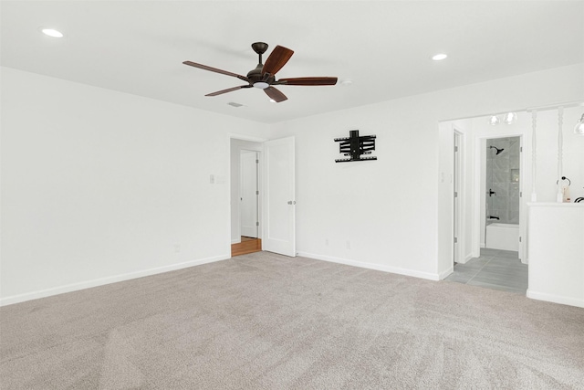 carpeted spare room with ceiling fan