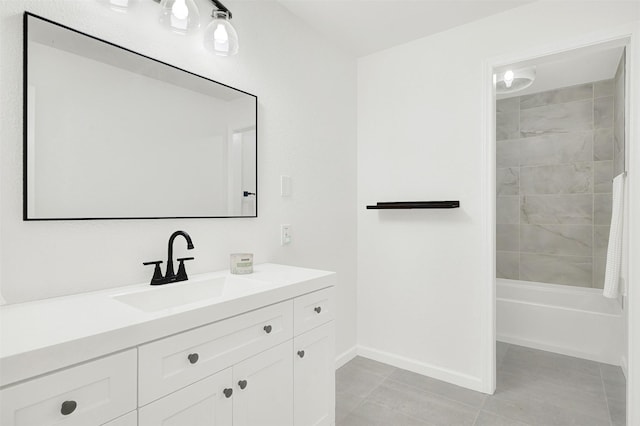 bathroom featuring tile patterned flooring, vanity, and tiled shower / bath