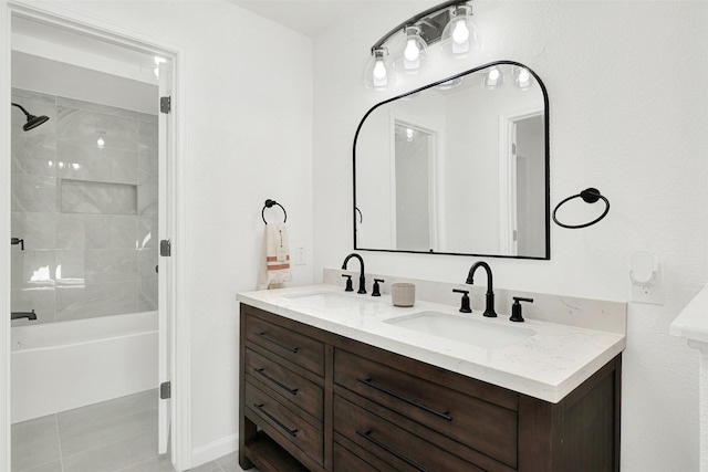 bathroom featuring tile patterned flooring, vanity, and tiled shower / bath