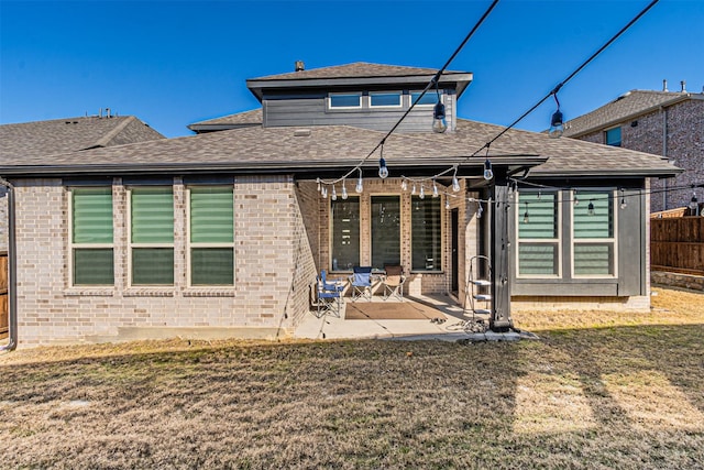 rear view of house with a patio and a lawn