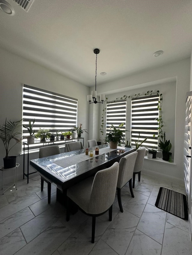 dining area featuring a notable chandelier