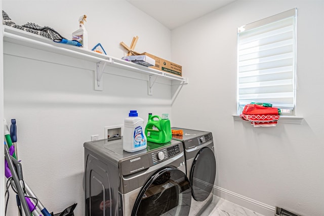 laundry area with washer and dryer and a baseboard radiator