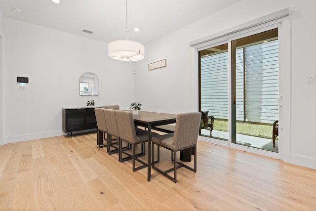 dining space with light hardwood / wood-style floors