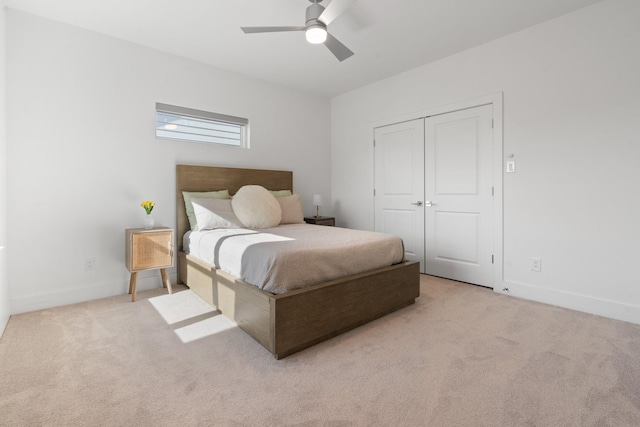 carpeted bedroom featuring ceiling fan and a closet