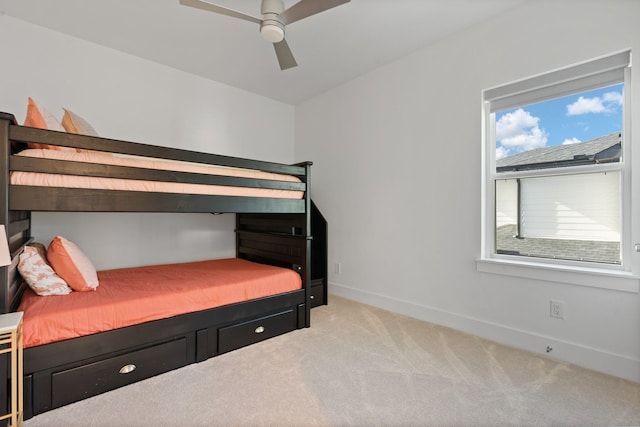 bedroom with light carpet and ceiling fan