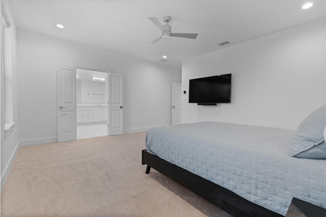 carpeted bedroom with connected bathroom and ceiling fan