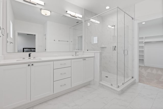 bathroom featuring vanity and an enclosed shower