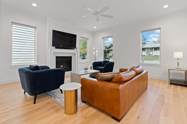 living room with ceiling fan and light wood-type flooring