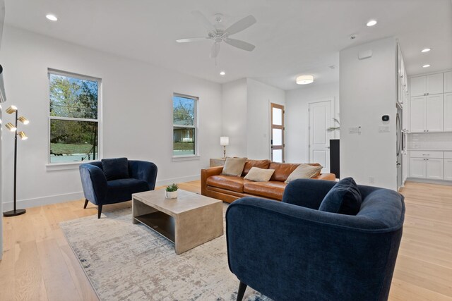 living room featuring ceiling fan, a healthy amount of sunlight, and light hardwood / wood-style flooring