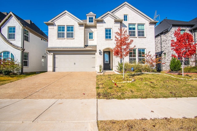 view of front facade with a garage and a front lawn