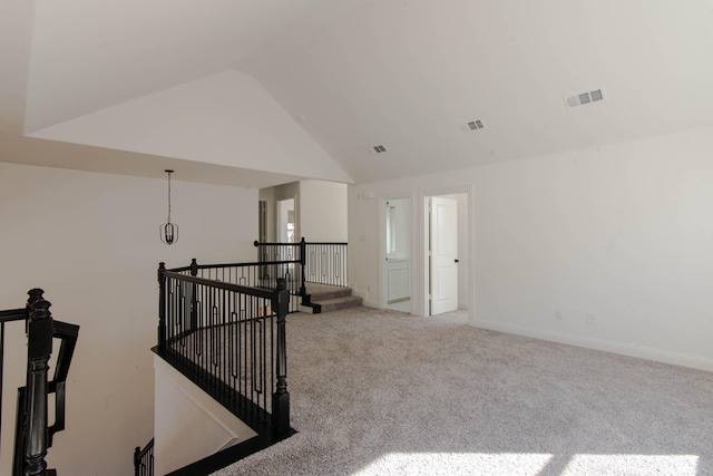 empty room featuring carpet floors and lofted ceiling