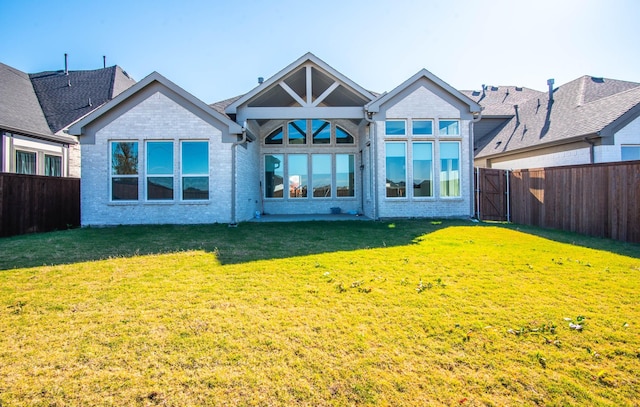 rear view of house with a lawn