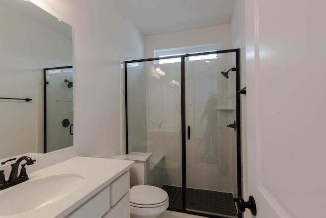 bathroom featuring vanity and a shower with door