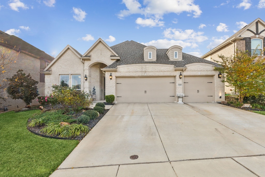 view of front of property with a garage and a front yard