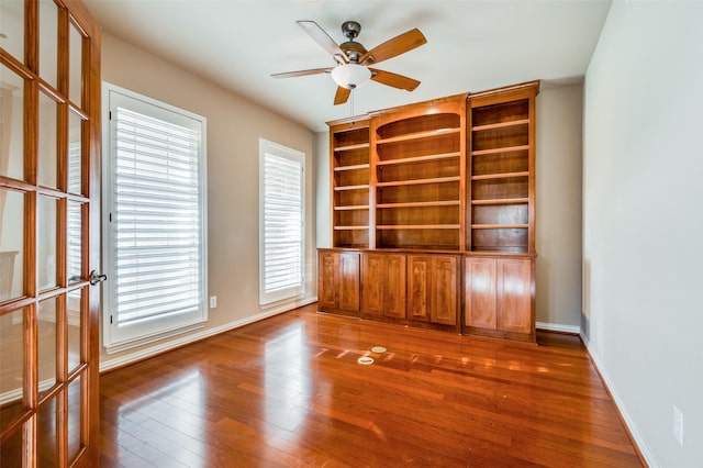 empty room featuring ceiling fan and dark hardwood / wood-style flooring